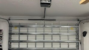 White raised-panel garage door with window lites seen from inside
